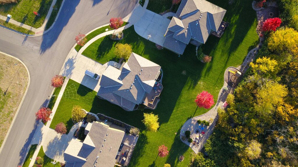 pexels-photo-1546166-1546166 A picturesque aerial view showcasing suburban homes with vibrant gardens and tree-lined streets.